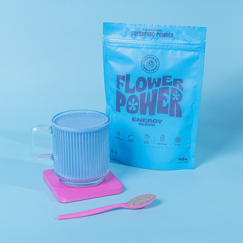 tropical additions superfood blends - Flower Power energy blend packet next to blue latte